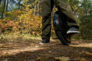 man rides down the trail on a monocycle. close up unicycle. photo