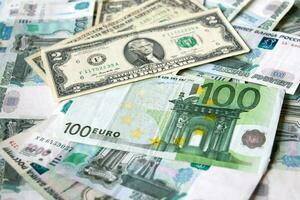 background of paper bills dollars, euros and rubles. Currency exchange rate photo