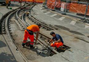 Workers at work while sistenabo the tram rails photo