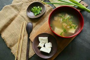 miso soup or Japanese miso soup in bowl on the table. Japanese cuisine in the form of soup with dashi ingredients, tofu, seafood, vegetables, and topped with miso to taste photo