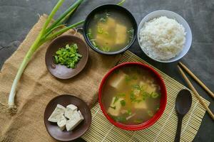 miso soup or Japanese miso soup in bowl on the table. Japanese cuisine in the form of soup with dashi ingredients, tofu, seafood, vegetables, and topped with miso to taste photo