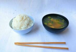 miso soup or Japanese miso soup in bowl on the table. Japanese cuisine in the form of soup with dashi ingredients, tofu, seafood, vegetables, and topped with miso to taste photo