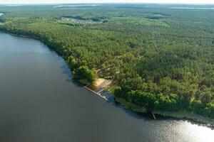 panorama aerial view over lake among forest photo