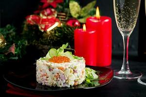 Christmas table setting. Traditional Russian salad Olivier. New Year salad. Festive salad. photo