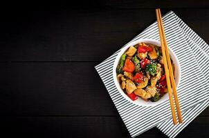 Stir fry with chicken, mushrooms, broccoli and peppers. Chinese food. Top view, overhead photo