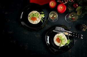 Christmas table setting. Traditional Russian salad Olivier. New Year salad. Festive salad. photo