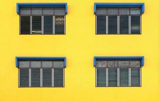 4 windows with a yellow background and painted blue windows photo