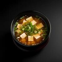 Food photography of Miso Soup on black bowl isolated on dark background. photo
