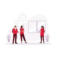 A woman gesturing and discussing something with a smile while her coworkers listen to her standing in the corner of the office. Discussion concept. Trend Modern vector flat illustration