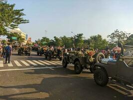 an army car in the parade of surabaya anniversary. Surabaya, indonesia - may, 2023 photo