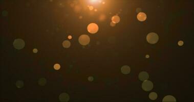 Abstract background of yellow orange gold glowing particles and bokeh dots of festive energy magic photo
