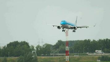 AMSTERDAM, THE NETHERLANDS JULY 27, 2017 - Passenger jet of KLM landing, slow. KLM Cityhopper Embraer 175 at Schiphol Airport, Amsterdam. Tourism and travel concept. video