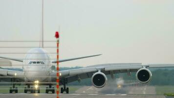 DUSSELDORF, GERMANY JULY 23, 2017 - Passenger Airbus A380 of Emirates taxiing after landing to the terminal at Dusseldorf airport, front view. Tourism and travel concept video