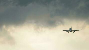 Jet plane against a stormy gray sky. Airliner approaching landing in rainy weather video