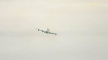 Huge passenger plane flies away, climb. Four engine airliner departure, rear view. Airplane takeoff, long shot video