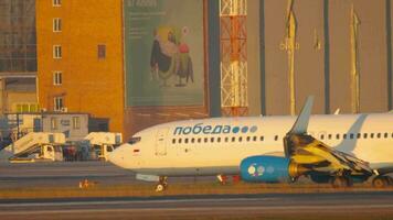 NOVOSIBIRSK, RUSSIAN FEDERATION JUNE 17, 2020 - Pobeda airline aircraft in international airport Tolmachevo. Commercial plane taxi to the terminal after landing. Pobeda is low cost airline video