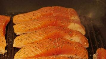 A deliciously grilled salmon fillet cooking on a stovetop pan video