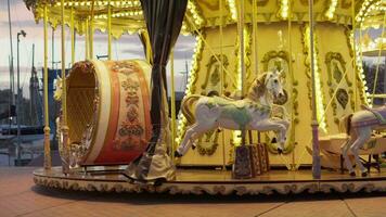 A colorful carousel with beautifully decorated horses spinning in a city street video