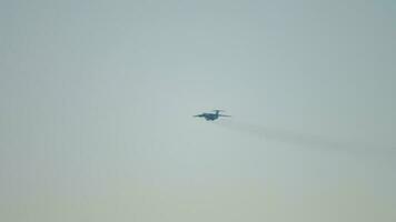 Silhouette of a military aircraft in the sky. Military transport aircraft with turbojet engines on final approach video