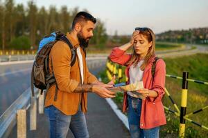 Tourists are using map in the city. They are sightseeing the city and arguing about what to see. photo