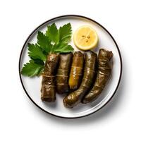 Photo of dolma with lemon on plate isolated on white background. Created by Generative AI