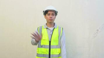 Indonesian worker wear vest and white helmet with disagree pose. The footage is suitable to use for engineer and safety content media. video