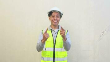 Indonesian worker wear vest and white helmet feel happy and cheers. The footage is suitable to use for engineer and safety content media. video