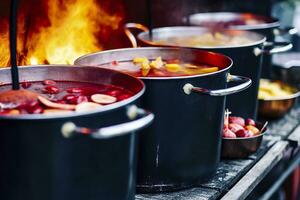 Beverages fruits and berries hot mulled wine in pots with steam in street food market. Generative AI photo