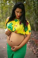 Pregnant woman posing in a park photo