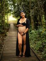 Pregnant woman posing in nature photo