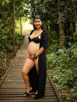 Pregnant woman posing in nature photo