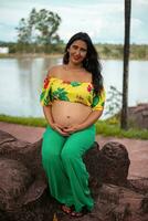 Pregnant woman posing in a park photo