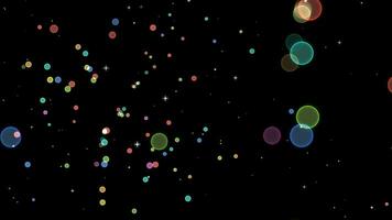 Large bubble falling and blur rainbow colorful circle burst effect white star floating on the black screen video