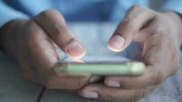 close up of a man's hands holding a cell phone video