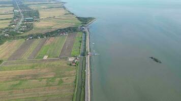 An aerial view Ban Pecah near sea and paddy field video