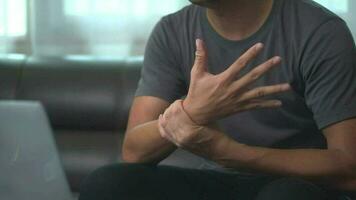 Close up hand of asian man he massages  wrist hurts using  laptop for long period of time. video