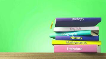 School textbooks are stacked. Back to school concept stop motion animation video, Education and reading concept - group of colorful books and pencils on the wooden table. video