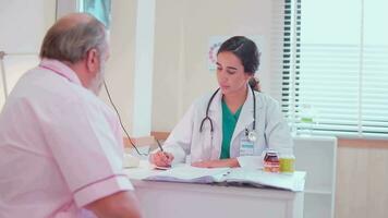 Female doctor and professional nutritionist in uniform advise Caucasian patients about supplementary foods and nutrients for healthy diet at clinic hospital, checkups, and appointments. video