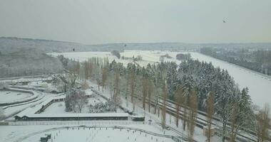 Aerial view of a stable and equestrian training ground after a snow storm video