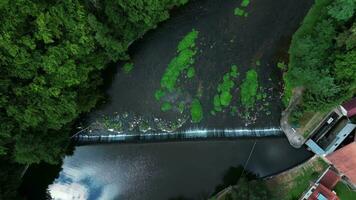 Aerial top down view of a weir on river near old mill video