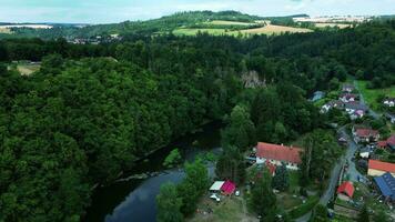 Aerial orbiting view of old mill on river and village video