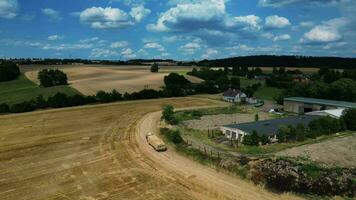 Aerial view of a tractor with trailer and hay packages video