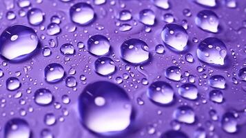 , Lavender color. Texture of light violet purple gel with drops and waves on soft background. Liquid beauty product closeup photo