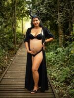 Pregnant woman posing in nature photo