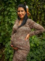 Pregnant woman posing in nature photo