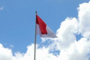 17 August 1945, Indonesian flag against sky background. Independence day concept photo