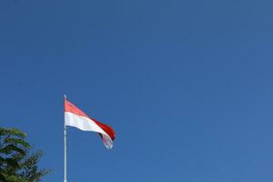 17 August 1945, Indonesian flag against sky background. Independence day concept photo