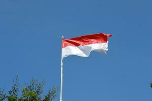 17 August 1945, Indonesian flag against sky background. Independence day concept photo