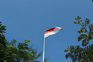 17 August 1945, Indonesian flag against sky background. Independence day concept photo