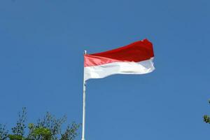 17 August 1945, Indonesian flag against sky background. Independence day concept photo